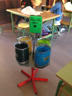 there are many buckets on the table in this room and one has a sign