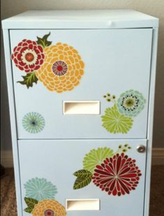 a white cabinet with colorful flowers painted on it