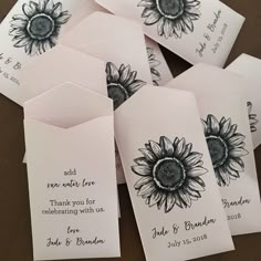 sunflowers are on top of white envelopes with the words, and thank you for celebrating with us