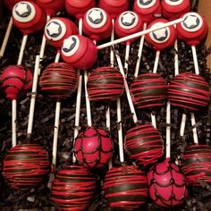 red and black cake pops with spiderman faces on them