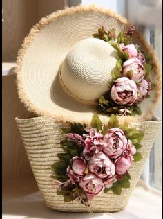 a straw hat with flowers is sitting on a window sill