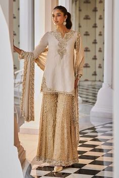 Silver kurta featuring heavy sequin, crystal and pearl embroidery in tones of antique gold and tassels. Paired with heavily embroidered contrasting sharara and embroidered floral border dupatta. - Aza Fashions Pearl Embroidery, Floral Border, Antique Gold, Tassels, Sequin, Floral, Gold