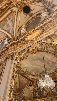 an ornate ceiling with chandeliers and paintings on it