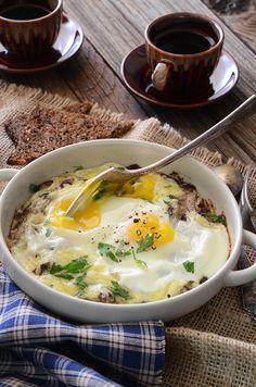 an egg in a bowl with bread on the side