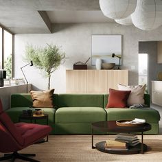 a living room filled with lots of furniture and pillows on top of a rug next to a coffee table