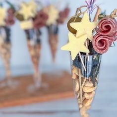 a vase filled with flowers and stars on top of a table