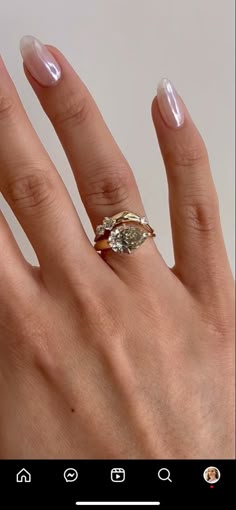 a woman's hand with two rings on it and one ring in the middle