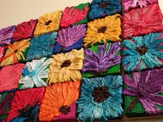 colorful flowers are arranged in squares on the table