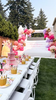 a table set up for a princess themed birthday party with balloons and paper plates on it