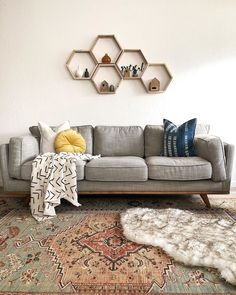 a living room filled with furniture and rugs on top of a carpeted floor