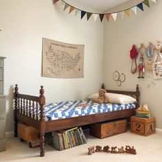 a child's bedroom with toys on the floor and a map hanging above it