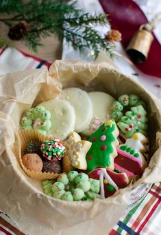 a basket filled with lots of different types of cookies and pastries on top of a table