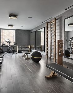 the gym is clean and ready for people to use it as an exercise center in this modern apartment