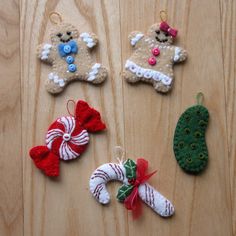 christmas ornaments are laid out on a wooden surface, including gingerbreads and candy canes