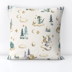 a white pillow with blue and gold stars, clouds, and gnomes on it