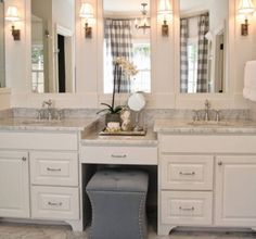 a bathroom with two sinks and three mirrors