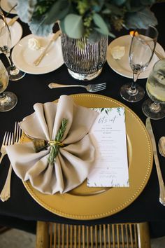 the table is set with silverware and place settings