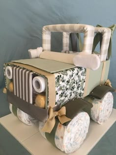 a cake made to look like a jeep with diapers on the front and sides