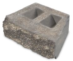 a concrete block with two holes in it on a white background, there is no image here to provide a caption for