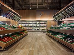 an empty grocery store filled with lots of fresh fruits and veggies on shelves