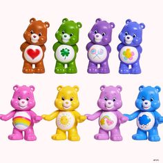 there are many colorful teddy bears holding hands