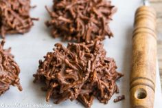 chocolate cookies on a baking sheet next to a rolling pin