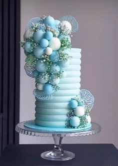 a three tiered cake with blue and white decorations