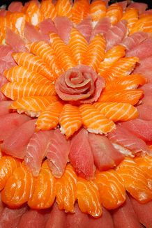 an arrangement of sushi arranged in the shape of a flower