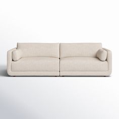 a white couch sitting on top of a white floor