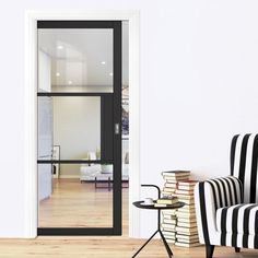 a black and white striped chair sitting in front of a glass door to a living room