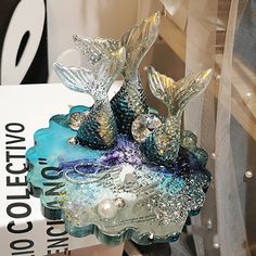 a glass figurine sitting on top of a table next to a sign that says coutectio