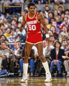 an autographed photo of two basketball players on the court with fans in the background