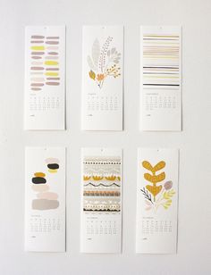 four calendars are hanging on the wall with different patterns and shapes in them,