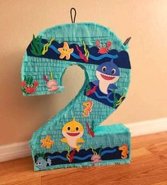 the number two is made out of toilet paper and decorated with cartoon characters, including shark, seahorse, starfish, and other marine creatures