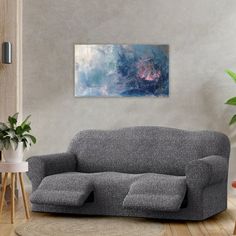 a living room scene with focus on the couch and chair, potted plant in the corner