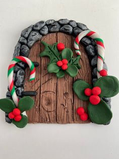 a wooden door decorated with candy canes and holly