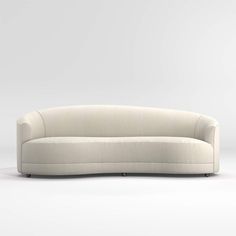 a white couch sitting on top of a white floor