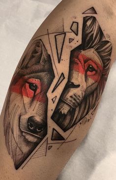 a man's leg with two wolfs on it, one is red and the other is black