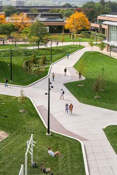 people are walking around on the grass in an open area