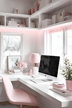 a white desk with a computer on top of it and pink chairs next to it