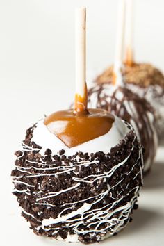 two cake pops with caramel on top and chocolate drizzle in the middle