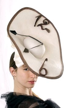 "A Statement Ascot Fascinator hat, Kentucky derby fascinator, Melbourne cup hat inspired by Salvador Dali's \"Nobility of time\". This extraordinary \"Watch\" hat is made from ivory paper, brown sinamey numbers and black feather hands/arrows. there is also a big bow-knot and for better stability the hat is secured with milliner elastic. Unique hat! This amazing hat is made to order - please let us 1-2 weeks to recreate it Please send me your head size when ordering so we can adjust it for you. A Navy Fascinator, Racing Fashion, Statement Hat, Kentucky Derby Fascinator, Royal Ascot Hats, Derby Outfits, Derby Fascinator, Ascot Hats, Hat Fascinator