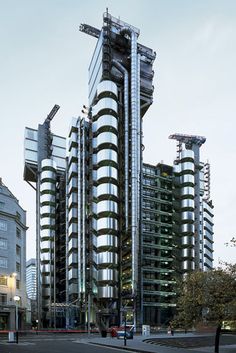 a tall building with lots of windows on top of it's sides in front of other buildings