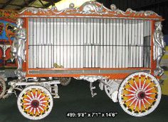 an orange and white cart with wheels on display