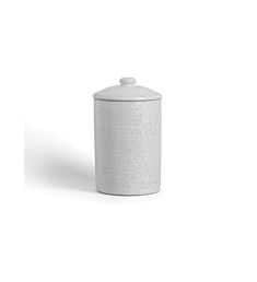 a white canister sitting on top of a table