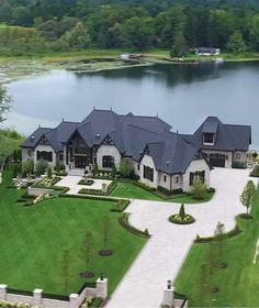 this is an aerial view of a large house in the middle of a beautiful lake