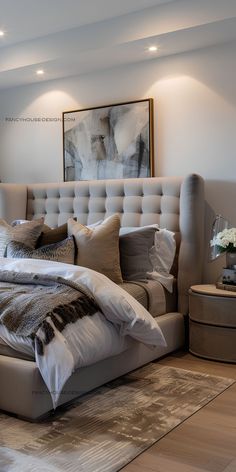 a large bed sitting in the middle of a bedroom