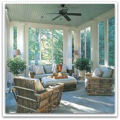 a sun room with wicker furniture and large windows