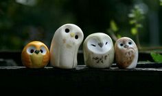 five small owls sitting on top of a wooden table