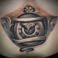 a chest with a clock and ribbon around it on top of someone's chest